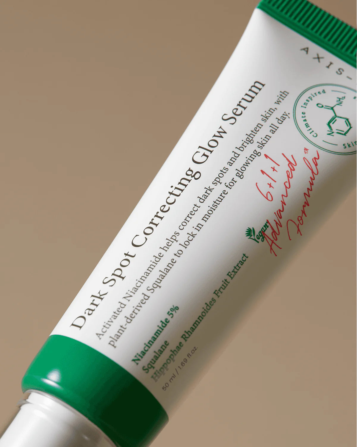 Tube of Axis Skincare Dark Spot Correcting Glow Serum on a beige background